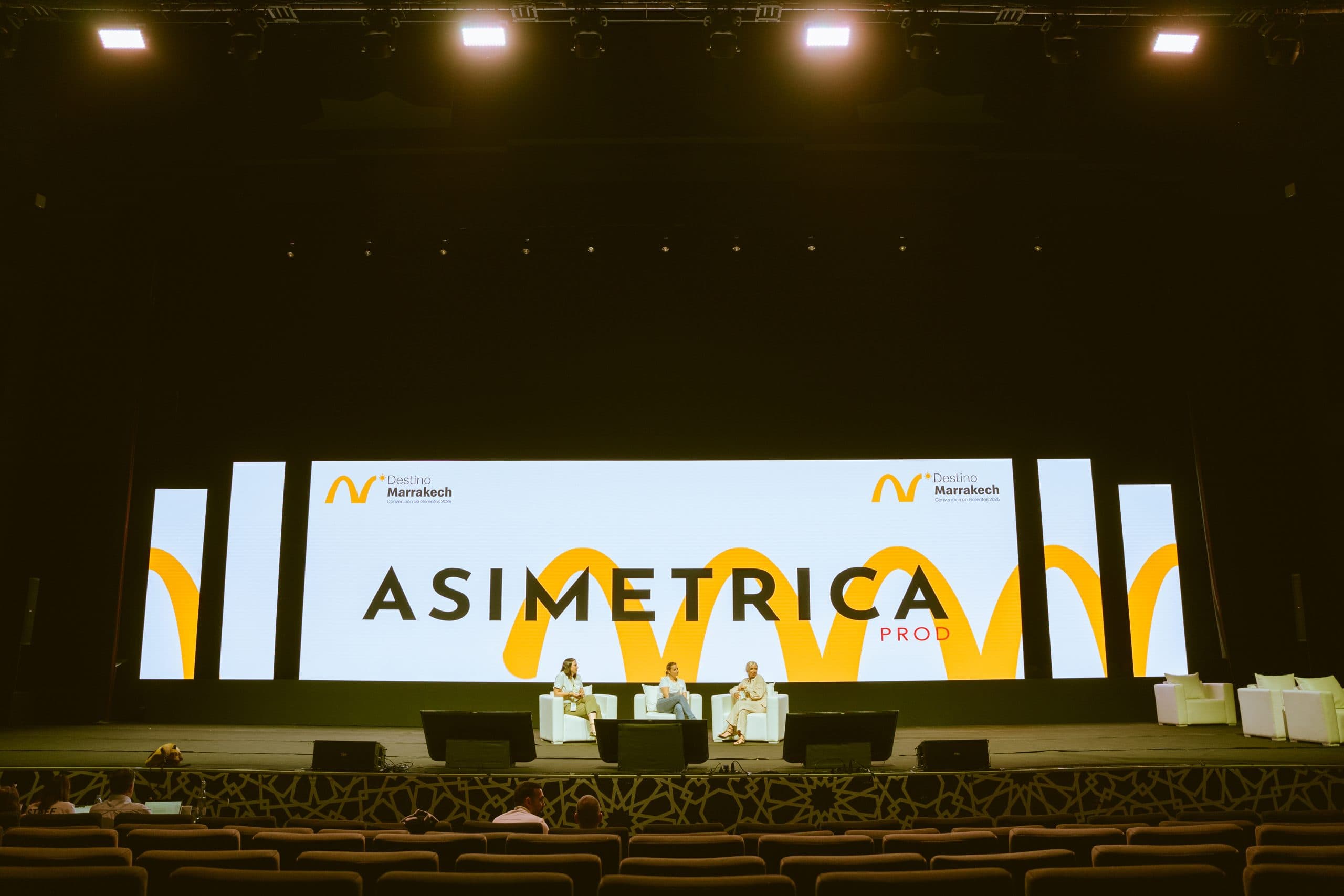 LED wall on a Marrakesh stage, with the Asimetrica Prod name across the screen