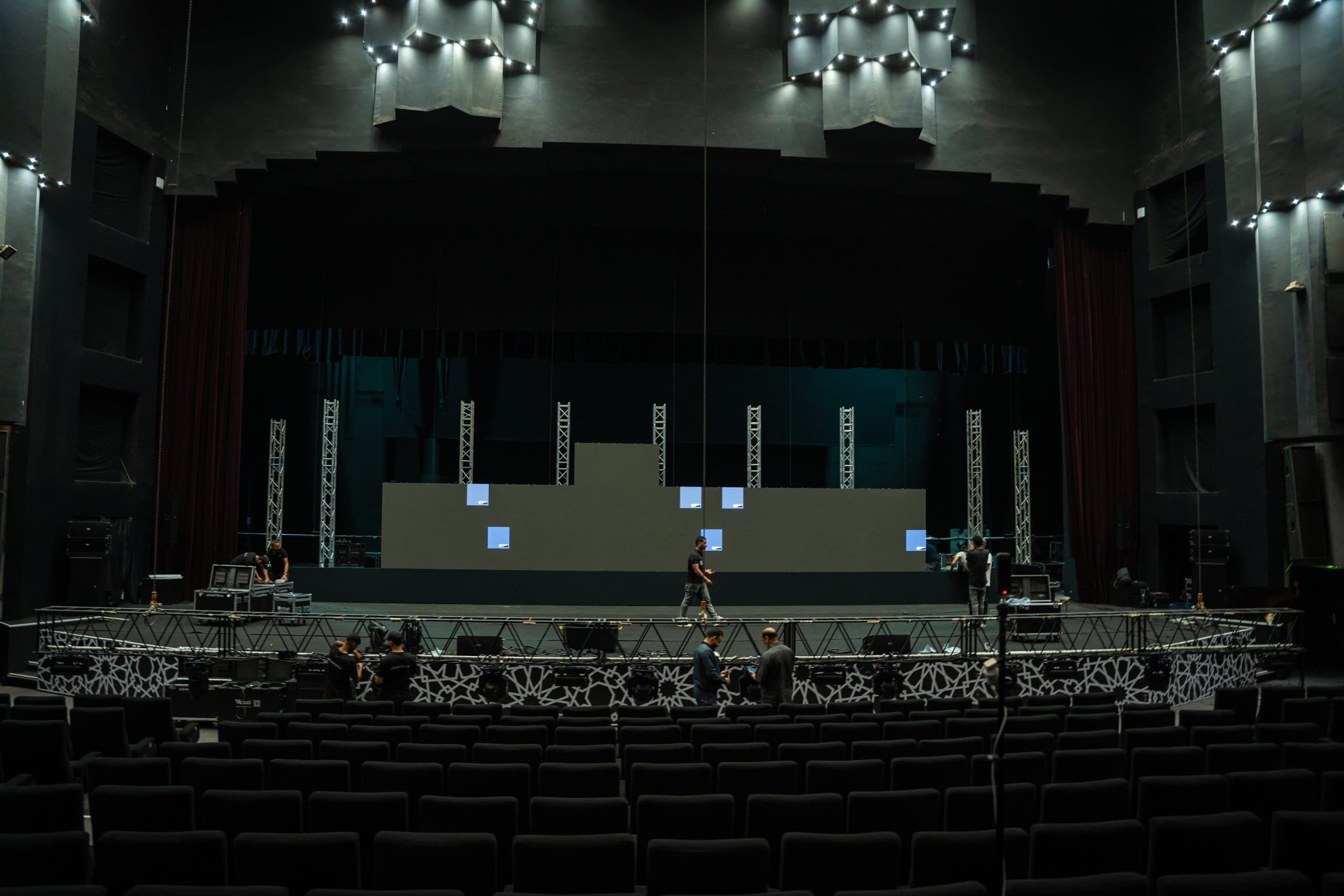 Crew building a stage and lighting truss in a Marrakesh hall
